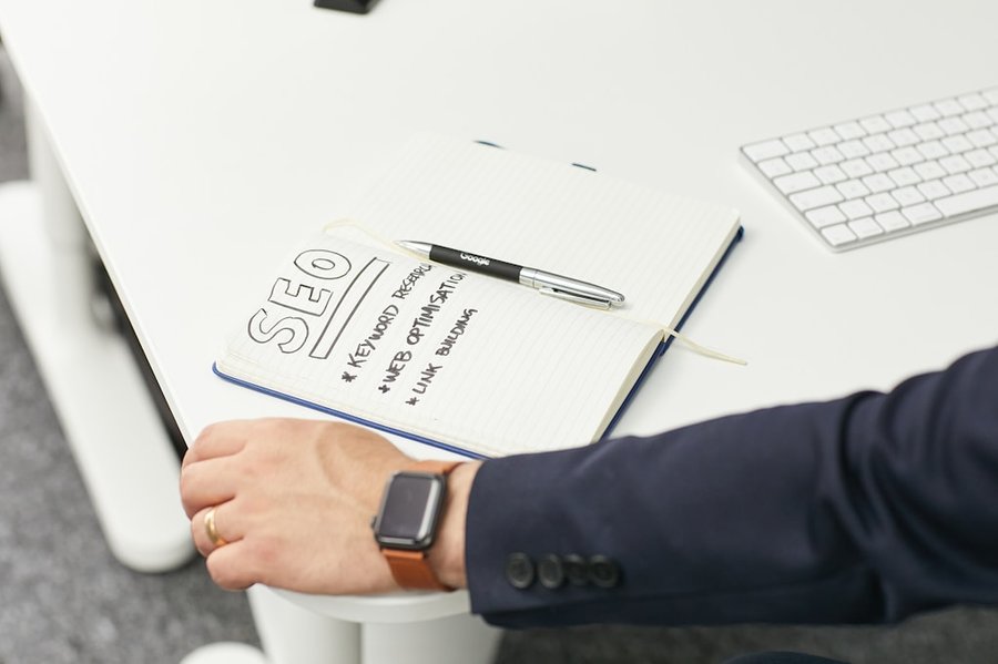 a person writing on a piece of paper